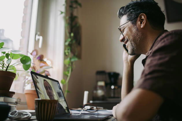 Businessman talking over smart phone during meeting on video call with colleague at home office Sweden, Stockholm, model released, property released Copyright: xMaskotx , MA86229