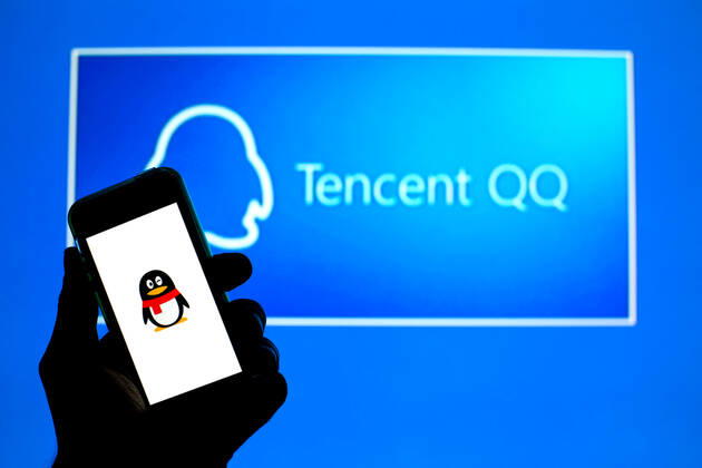 April 30, 2021, Barcelona, Catalonia, Spain: In this photo illustration, the Tencent QQ app seen displayed on a smartphone screen and a Tencent QQ logo in the background. Barcelona Spain - ZUMAd159 20210430_zia_d159_021 Copyright: xThiagoxPrudenciox