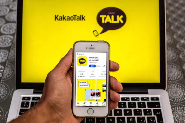 April 30, 2021, Barcelona, Catalonia, Spain: In this photo illustration, the KakaoTalk app in App Store seen displayed on a smartphone screen and a KakaoTalk logo on a laptop in the background. Barcelona Spain - ZUMAd159 20210430_zia_d159_001 Copyright: xThiagoxPrudenciox
