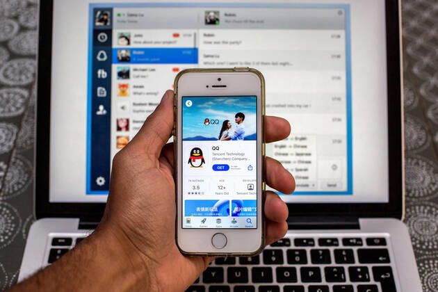 April 30, 2021, Barcelona, Catalonia, Spain: In this photo illustration, the Tencent QQ app in App Store seen displayed on a smartphone screen and a Tencent QQ Desktop on a laptop in the background. Barcelona Spain - ZUMAd159 20210430_zia_d159_004 Copyright: xThiagoxPrudenciox