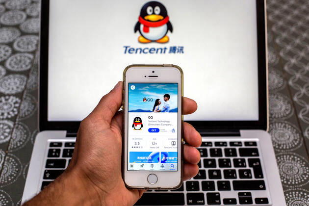 April 30, 2021, Barcelona, Catalonia, Spain: In this photo illustration, the Tencent QQ app in App Store seen displayed on a smartphone screen and a Tencent QQ logo on a laptop in the background. Barcelona Spain - ZUMAd159 20210430_zia_d159_005 Copyright: xThiagoxPrudenciox
