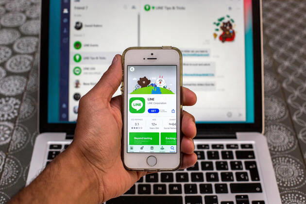 April 30, 2021, Barcelona, Catalonia, Spain: In this photo illustration, the Line app in App Store seen displayed on a smartphone screen and a Line Desktop on a laptop in the background. Barcelona Spain - ZUMAd159 20210430_zia_d159_008 Copyright: xThiagoxPrudenciox
