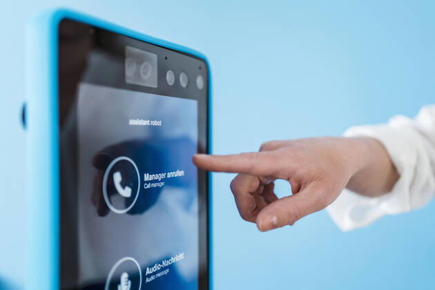 Businesswoman touching robotic assistant in office model released Symbolfoto property released DIGF15739
