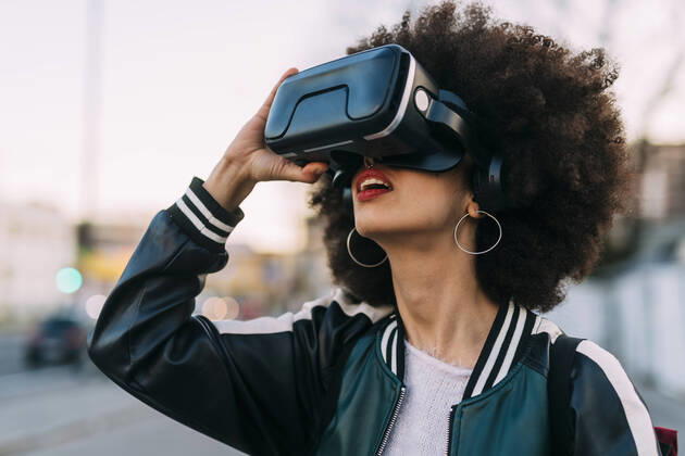 Young afro hairstyle woman using virtual reality headset model released Symbolfoto MEUF03013