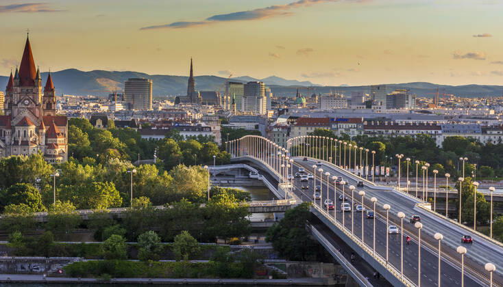 sunset panorama of Vienna city center from North-East: , river Donau (Danube), island Donauinsel, bridge Reichsbrücke, church Franz von Assisi, cathedral Stephansdom (St. Stephen s Cathedral) Wien, Vienna Wien Austria 00. overview