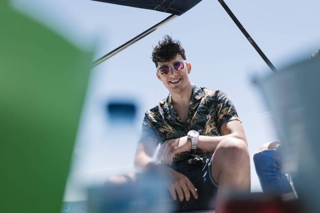 Smiling handsome man sitting on yacht during vacation model released Symbolfoto EGAF02454