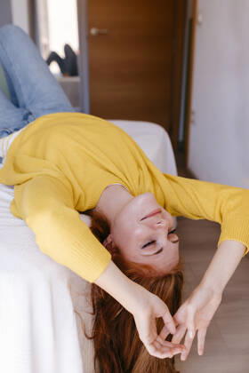 Young woman resting on bed in bedroom at home model released Symbolfoto property released TCEF01276