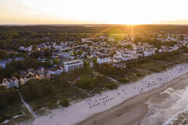 Germany, Mecklenburg-Western Pomerania, Heringsdorf, Aerial view of coastal town at sunset with clear line of horizon in background WDF06361