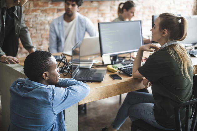 Male and female programmers coding over computer in office Sweden, Stockholm, model released, property released Copyright: xMaskotx , MA87949