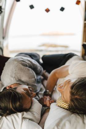 Male friends lying on side at camping van during vacation Sweden, Gothenburg, model released, property released Copyright: xMaskotx , MA88049