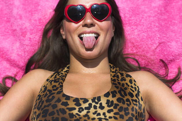 Portrait of young woman sunbathing pulling a face, 28.08.2014, Copyright: xStevexPrezantx, model released, wearing,lying on back,sunbathing,looking at camera,black hair,pink,front view,head and shoulders,leopard skin,portrait,heart shape,at home,fun,humor,confidence,happiness,relaxation,beach towel,20 to 24 years,caucasian ethnicity,female,woman,young woman,only one young woman,one person,outdoors,garden,summer,day,sunglasses,swimwear,swimming costume,making faces,smiling,sticking out tongue,long hair,lifestyle,sunlight,leisure,vacation,only female,September 2014 Release,Reclining,Lying On Back,Sunbathing,Caucasian Ethnicity,Young Adult,20-24 Years,Female,Women,Young Women,Young Adult Woman,Confidence,Enjoyment,Fun,Humor,Relaxation,Wellb Ref:IS09AK7XU
