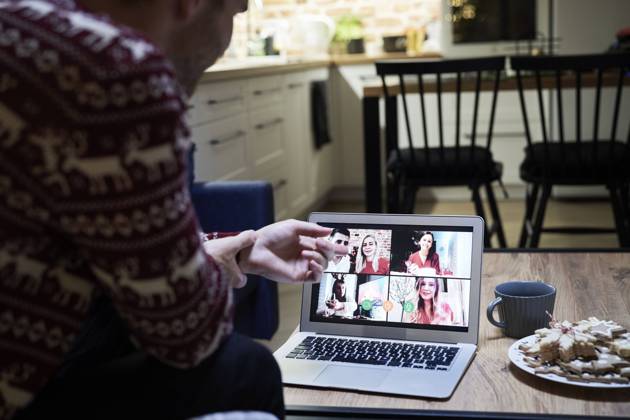 Young man talking with family through video conference during Christmas model released Symbolfoto property released ABIF01621