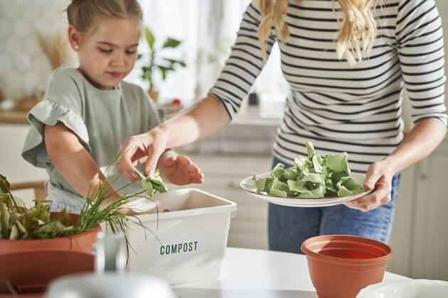 Mother and daughter making compost at home model released Symbolfoto property released ABIF01610