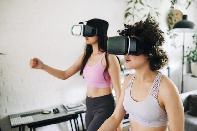 Friends with virtual reality headsets exercising together at home model released Symbolfoto property released ASGF01108