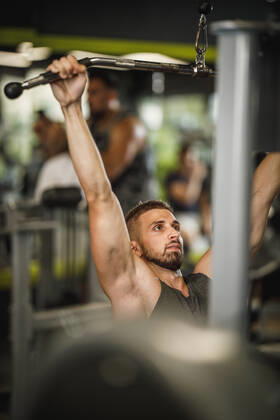 Upping My Endurance Shot of a muscular guy in sportswear working out at the gym machine. He is pumping up back muscle with heavy weight. Copyright: xMilanxMarkovicx 38798336