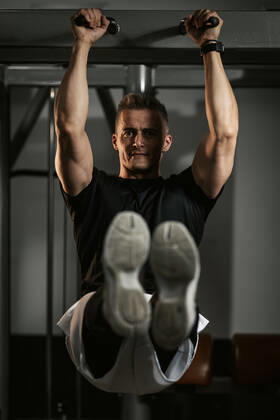Fitness For Healthy Lifestyle Muscular young man in sportswear focused on doing sit-up exercises during a strength training workout at the gym. Copyright: xMilanxMarkovicx 38999660