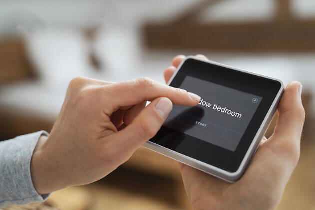 Woman using touch screen smart home device model released Symbolfoto property released DIGF16582