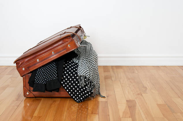 Black and white polka dot clothes in a retro leather suitcase. Copyright: xx 5466968