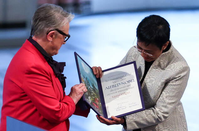 OSLO, NORWAY â€“ DECEMBER 10, 2021: Norwegian Nobel Committee Chairwoman Berit Reiss-Andersen (L) presents the 2021 Nobel Peace Prize to Filipino-American journalist, co-founder and CEO of Rappler Maria Ressa in recognition of her efforts to safeguard freedom of expression, which is a precondition for democracy and lasting peace , at a ceremony at Oslo City Hall. Sergei Bobylev TASS  TS11B5FC