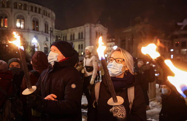 OSLO, NORWAY â€“ DECEMBER 10, 2021: People take part in a torchlight parade in honour of the 2021 Nobel Peace Prize winners from Oslo Central Station to the Grand Hotel where the laureates greet the procession participants from the balcony. The Norwegian Nobel Committee has decided to award the Nobel Peace Prize for 2021 to Filipino-American journalist, co-founder and CEO of Rappler Maria Ressa and Russian journalist, Novaya Gazeta editor-in-chief Dmitry Muratov in recognition of their efforts to safeguard freedom of expression, which is a precondition for democracy and lasting peace . Sergei Bobylev TASS  TS11B672