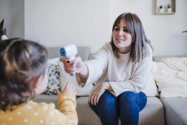 Mother measuring temperature of baby girl at home model released property released, EBBF05092