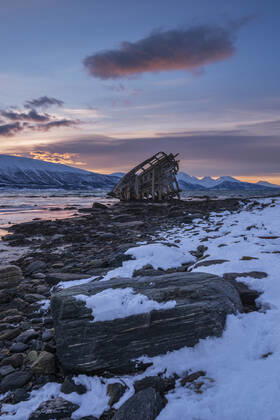 Shipwreck lying on shore of secluded Fjord at winter dawn, RUEF03453