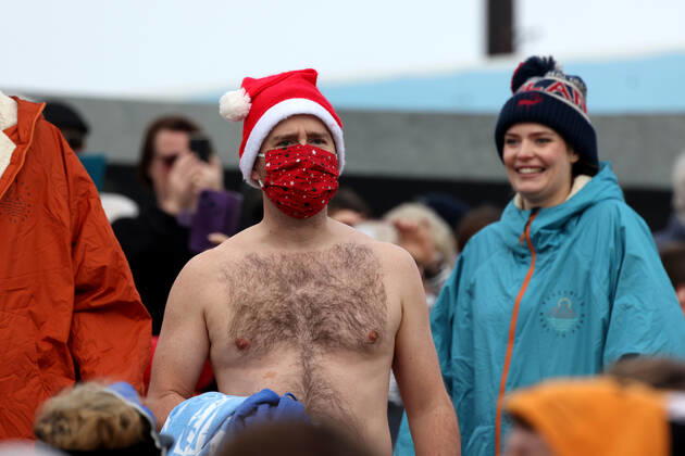 Over 350 New Year revellers, many in fancy dress, take part in the New Year Big Dip at East Wittering Beach in Chichester, West Sussex. More than double the previous record number of people took part, making the most of the warmest New YearÕs Day on record in the UK. JANUARY 1st 2022  MTXx2201