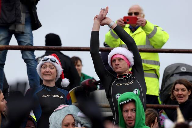 Over 350 New Year revellers, many in fancy dress, take part in the New Year Big Dip at East Wittering Beach in Chichester, West Sussex. More than double the previous record number of people took part, making the most of the warmest New YearÕs Day on record in the UK. JANUARY 1st 2022  MTXx2201