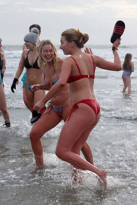 Over 350 New Year revellers, many in fancy dress, take part in the New Year Big Dip at East Wittering Beach in Chichester, West Sussex. More than double the previous record number of people took part, making the most of the warmest New YearÕs Day on record in the UK. JANUARY 1st 2022  MTXx2201