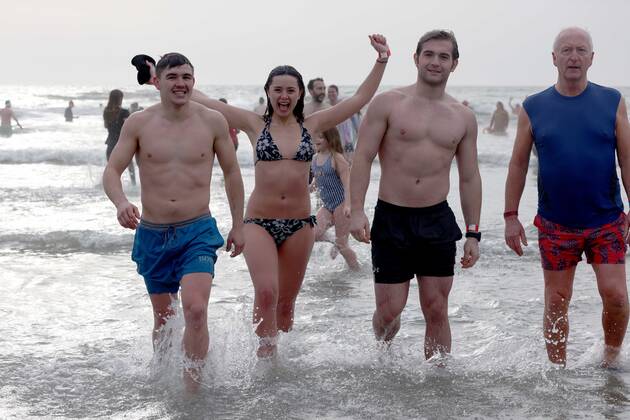 Over 350 New Year revellers, many in fancy dress, take part in the New Year Big Dip at East Wittering Beach in Chichester, West Sussex. More than double the previous record number of people took part, making the most of the warmest New YearÕs Day on record in the UK. JANUARY 1st 2022  MTXx2201