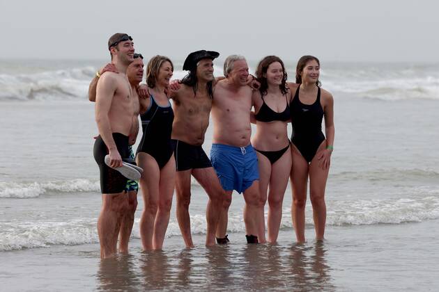Over 350 New Year revellers, many in fancy dress, take part in the New Year Big Dip at East Wittering Beach in Chichester, West Sussex. More than double the previous record number of people took part, making the most of the warmest New YearÕs Day on record in the UK. JANUARY 1st 2022  MTXx2201