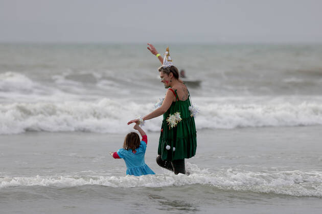 Over 350 New Year revellers, many in fancy dress, take part in the New Year Big Dip at East Wittering Beach in Chichester, West Sussex. More than double the previous record number of people took part, making the most of the warmest New YearÕs Day on record in the UK. JANUARY 1st 2022  MTXx2201