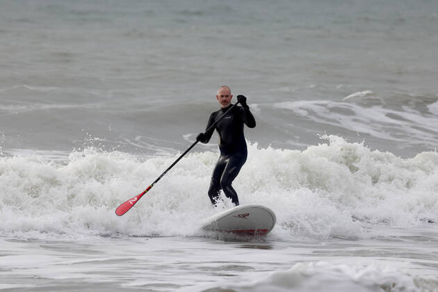 A paddle boarder makes the most of the warmest New YearÕs Day on record in the UK at East Wittering Beach in Chichester, West Sussex. JANUARY 1st 2022  MTXx2201