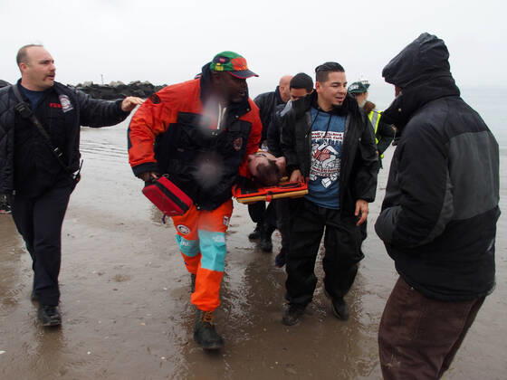 January 1, 2022, New York, New York, USA: January 1, 2022 New York , Coney Island Polar Bear Plunge. This year the Polar Bear Plunge returned after last year s Covid outbreak. Revelers enjoy the water..Participant prior to massive cardiac event and Emergency medical personnel try and revive him before transporting him to area hospital. New York USA - ZUMAct2_ 20220101_zaf_ct2_091 Copyright: xBrucexCotlerx