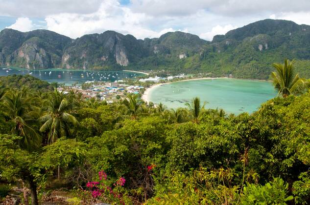 Ko Phi Phi consists of two islands, Phi Phi Leh and Phi Phi Don, located southeast of Phuket. Both are part of Hat Noppharat Thara Ko Phi Phi National Marine Park.<br ><br > Set in the centre of the Sea of Phuket, Ko Phi Phi is almost equidistant from Phuket and Krabi and can be reached by boat in around two hours.<br ><br > Phi Phi Don is the larger of the two islands, with scenic hills, steep cliffs, silken beaches, azure waters and remarkable bird- and sea-life. The island narrows at the middle where long, white-sand beaches are only a few hundred metres apart. Boats from Krabi and Phuket dock at Ao Ton Sai on the southern side of the island. Hat Yao or Long Beach faces south and is famous for the good snorkelling to be had on its co CPAxMediaxCo.xLtd. 1060_14_CPA0011091