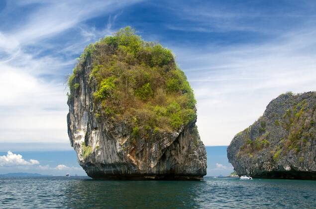 Ko Phi Phi consists of two islands, Phi Phi Leh and Phi Phi Don, located southeast of Phuket. Both are part of Hat Noppharat Thara Ko Phi Phi National Marine Park.<br ><br > Set in the centre of the Sea of Phuket, Ko Phi Phi is almost equidistant from Phuket and Krabi and can be reached by boat in around two hours.<br ><br > Phi Phi Don is the larger of the two islands, with scenic hills, steep cliffs, silken beaches, azure waters and remarkable bird- and sea-life. The island narrows at the middle where long, white-sand beaches are only a few hundred metres apart. Boats from Krabi and Phuket dock at Ao Ton Sai on the southern side of the island. Hat Yao or Long Beach faces south and is famous for the good snorkelling to be had on its co CPAxMediaxCo.xLtd. 1060_14_CPA0011095