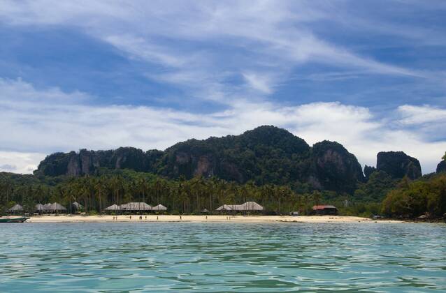 Ko Phi Phi consists of two islands, Phi Phi Leh and Phi Phi Don, located southeast of Phuket. Both are part of Hat Noppharat Thara Ko Phi Phi National Marine Park.<br ><br > Set in the centre of the Sea of Phuket, Ko Phi Phi is almost equidistant from Phuket and Krabi and can be reached by boat in around two hours.<br ><br > Phi Phi Don is the larger of the two islands, with scenic hills, steep cliffs, silken beaches, azure waters and remarkable bird- and sea-life. The island narrows at the middle where long, white-sand beaches are only a few hundred metres apart. Boats from Krabi and Phuket dock at Ao Ton Sai on the southern side of the island. Hat Yao or Long Beach faces south and is famous for the good snorkelling to be had on its co CPAxMediaxCo.xLtd. 1060_14_CPA0013655
