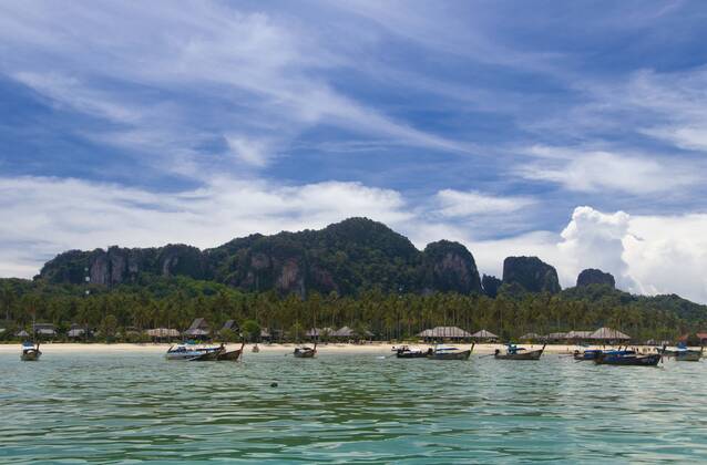 Ko Phi Phi consists of two islands, Phi Phi Leh and Phi Phi Don, located southeast of Phuket. Both are part of Hat Noppharat Thara Ko Phi Phi National Marine Park.<br ><br > Set in the centre of the Sea of Phuket, Ko Phi Phi is almost equidistant from Phuket and Krabi and can be reached by boat in around two hours.<br ><br > Phi Phi Don is the larger of the two islands, with scenic hills, steep cliffs, silken beaches, azure waters and remarkable bird- and sea-life. The island narrows at the middle where long, white-sand beaches are only a few hundred metres apart. Boats from Krabi and Phuket dock at Ao Ton Sai on the southern side of the island. Hat Yao or Long Beach faces south and is famous for the good snorkelling to be had on its co CPAxMediaxCo.xLtd. 1060_14_CPA0013657