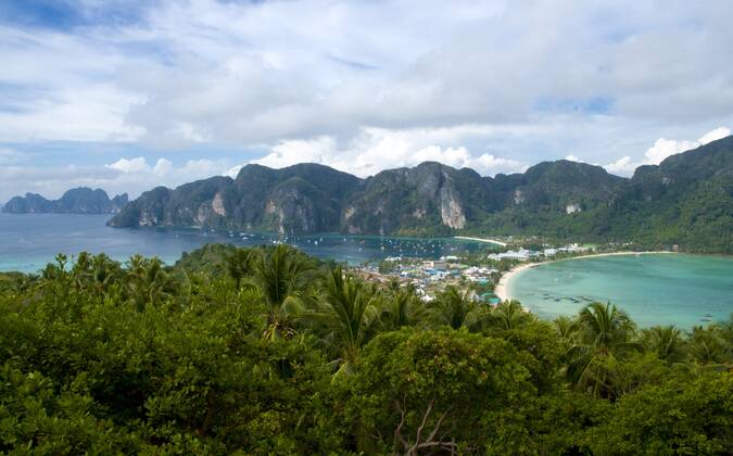 Ko Phi Phi consists of two islands, Phi Phi Leh and Phi Phi Don, located southeast of Phuket. Both are part of Hat Noppharat Thara Ko Phi Phi National Marine Park.<br ><br > Set in the centre of the Sea of Phuket, Ko Phi Phi is almost equidistant from Phuket and Krabi and can be reached by boat in around two hours.<br ><br > Phi Phi Don is the larger of the two islands, with scenic hills, steep cliffs, silken beaches, azure waters and remarkable bird- and sea-life. The island narrows at the middle where long, white-sand beaches are only a few hundred metres apart. Boats from Krabi and Phuket dock at Ao Ton Sai on the southern side of the island. Hat Yao or Long Beach faces south and is famous for the good snorkelling to be had on its co CPAxMediaxCo.xLtd. 1060_14_CPA0013663