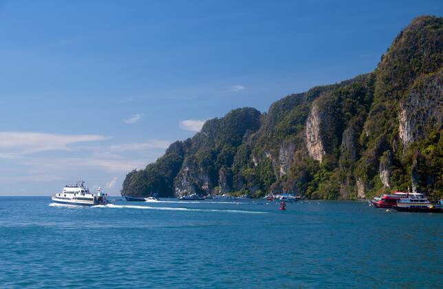 Ko Phi Phi consists of two islands, Phi Phi Leh and Phi Phi Don, located southeast of Phuket. Both are part of Hat Noppharat Thara Ko Phi Phi National Marine Park.<br ><br > Set in the centre of the Sea of Phuket, Ko Phi Phi is almost equidistant from Phuket and Krabi and can be reached by boat in around two hours.<br ><br > Phi Phi Don is the larger of the two islands, with scenic hills, steep cliffs, silken beaches, azure waters and remarkable bird- and sea-life. The island narrows at the middle where long, white-sand beaches are only a few hundred metres apart. Boats from Krabi and Phuket dock at Ao Ton Sai on the southern side of the island. Hat Yao or Long Beach faces south and is famous for the good snorkelling to be had on its co CPAxMediaxCo.xLtd. 1060_14_CPA0014873