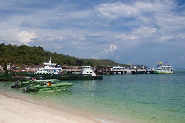 Ko Phi Phi consists of two islands, Phi Phi Leh and Phi Phi Don, located southeast of Phuket. Both are part of Hat Noppharat Thara Ko Phi Phi National Marine Park.<br ><br > Set in the centre of the Sea of Phuket, Ko Phi Phi is almost equidistant from Phuket and Krabi and can be reached by boat in around two hours.<br ><br > Phi Phi Don is the larger of the two islands, with scenic hills, steep cliffs, silken beaches, azure waters and remarkable bird- and sea-life. The island narrows at the middle where long, white-sand beaches are only a few hundred metres apart. Boats from Krabi and Phuket dock at Ao Ton Sai on the southern side of the island. Hat Yao or Long Beach faces south and is famous for the good snorkelling to be had on its co CPAxMediaxCo.xLtd. 1060_14_CPA0014904