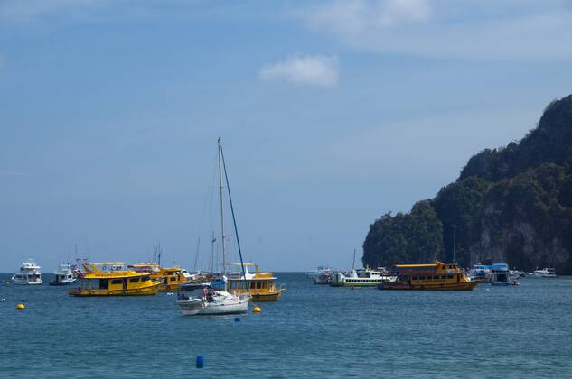 Ko Phi Phi consists of two islands, Phi Phi Leh and Phi Phi Don, located southeast of Phuket. Both are part of Hat Noppharat Thara Ko Phi Phi National Marine Park.<br ><br > Set in the centre of the Sea of Phuket, Ko Phi Phi is almost equidistant from Phuket and Krabi and can be reached by boat in around two hours.<br ><br > Phi Phi Don is the larger of the two islands, with scenic hills, steep cliffs, silken beaches, azure waters and remarkable bird- and sea-life. The island narrows at the middle where long, white-sand beaches are only a few hundred metres apart. Boats from Krabi and Phuket dock at Ao Ton Sai on the southern side of the island. Hat Yao or Long Beach faces south and is famous for the good snorkelling to be had on its co CPAxMediaxCo.xLtd. 1060_14_CPA0014905