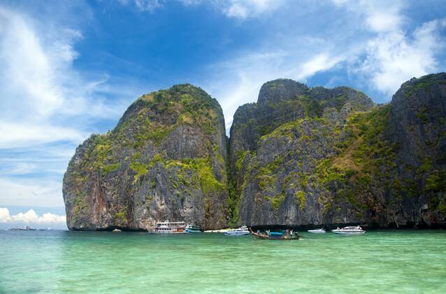 Ko Phi Phi consists of two islands, Phi Phi Leh and Phi Phi Don, located southeast of Phuket. Both are part of Hat Noppharat Thara Ko Phi Phi National Marine Park.<br ><br > Set in the centre of the Sea of Phuket, Ko Phi Phi is almost equidistant from Phuket and Krabi and can be reached by boat in around two hours.<br ><br > Phi Phi Don is the larger of the two islands, with scenic hills, steep cliffs, silken beaches, azure waters and remarkable bird- and sea-life. The island narrows at the middle where long, white-sand beaches are only a few hundred metres apart. Boats from Krabi and Phuket dock at Ao Ton Sai on the southern side of the island. Hat Yao or Long Beach faces south and is famous for the good snorkelling to be had on its co CPAxMediaxCo.xLtd. 1060_14_CPA0014909