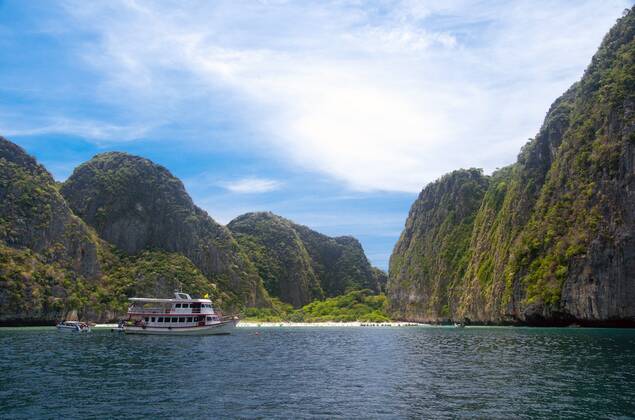 Ko Phi Phi consists of two islands, Phi Phi Leh and Phi Phi Don, located southeast of Phuket. Both are part of Hat Noppharat Thara Ko Phi Phi National Marine Park.<br ><br > Set in the centre of the Sea of Phuket, Ko Phi Phi is almost equidistant from Phuket and Krabi and can be reached by boat in around two hours.<br ><br > Phi Phi Don is the larger of the two islands, with scenic hills, steep cliffs, silken beaches, azure waters and remarkable bird- and sea-life. The island narrows at the middle where long, white-sand beaches are only a few hundred metres apart. Boats from Krabi and Phuket dock at Ao Ton Sai on the southern side of the island. Hat Yao or Long Beach faces south and is famous for the good snorkelling to be had on its co CPAxMediaxCo.xLtd. 1060_14_CPA0014912