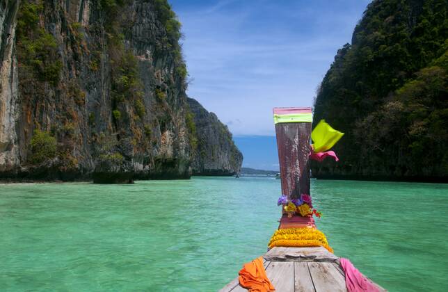 Ko Phi Phi consists of two islands, Phi Phi Leh and Phi Phi Don, located southeast of Phuket. Both are part of Hat Noppharat Thara Ko Phi Phi National Marine Park.<br ><br > Set in the centre of the Sea of Phuket, Ko Phi Phi is almost equidistant from Phuket and Krabi and can be reached by boat in around two hours.<br ><br > Phi Phi Don is the larger of the two islands, with scenic hills, steep cliffs, silken beaches, azure waters and remarkable bird- and sea-life. The island narrows at the middle where long, white-sand beaches are only a few hundred metres apart. Boats from Krabi and Phuket dock at Ao Ton Sai on the southern side of the island. Hat Yao or Long Beach faces south and is famous for the good snorkelling to be had on its co CPAxMediaxCo.xLtd. 1060_38_CPA0011088