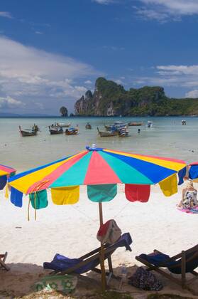 Ko Phi Phi consists of two islands, Phi Phi Leh and Phi Phi Don, located southeast of Phuket. Both are part of Hat Noppharat Thara Ko Phi Phi National Marine Park.<br ><br > Set in the centre of the Sea of Phuket, Ko Phi Phi is almost equidistant from Phuket and Krabi and can be reached by boat in around two hours.<br ><br > Phi Phi Don is the larger of the two islands, with scenic hills, steep cliffs, silken beaches, azure waters and remarkable bird- and sea-life. The island narrows at the middle where long, white-sand beaches are only a few hundred metres apart. Boats from Krabi and Phuket dock at Ao Ton Sai on the southern side of the island. Hat Yao or Long Beach faces south and is famous for the good snorkelling to be had on its co CPAxMediaxCo.xLtd. 1060_38_CPA0014896