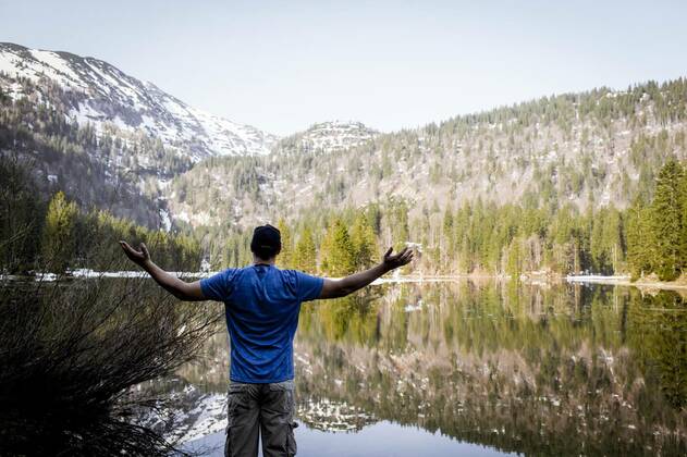 IMAGO Creative: Sommer, In den Bergen young man with cap and blue shirt is standing in front of mountain lake model released, Symbolfoto, 12.10.2020, Copyright: xphotographie_Hannes_Eichingerx Panthermedia25742302