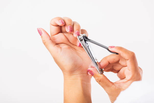 Close up young Asian woman have tool cutting nails fingernails on finger using a nail clipper. Female using tweezers by herself, studio shot isolated on white background, Healthcare concept Copyright: xSORAPOPxUDOMSRIx 37530770