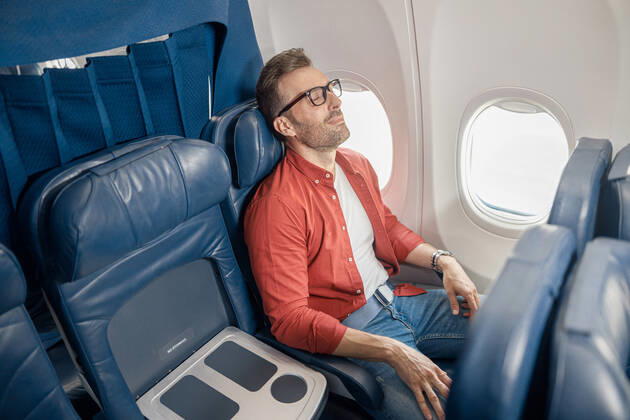 Handsome caucasian man in casual wear resting on the plane, sitting near the window Handsome caucasian man in casual wear resting on the plane, sitting near the window. Relax, travel, vacation, transportation concept Copyright: xyaroslavxastakhovx 40888594