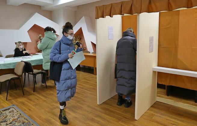 (220222) -- MINSK, Feb. 22, 2022 -- A voter writes on her ballot at a polling station in Minsk, Belarus, Feb. 22, 2022. Early voting for a nationwide referendum on amending the country s constitution begins in Belarus on Tuesday and will last until Saturday. The referendum will be considered valid if more than half of the eligible voters cast their ballots. The question put on the ballot paper is: Do you accept amendments and additions to the Constitution of the Republic of Belarus? (Photo by Xinhua) BELARUS-MINSK-CONSTITUTION AMENDMENT-VOTING HenadzxZhinkov 